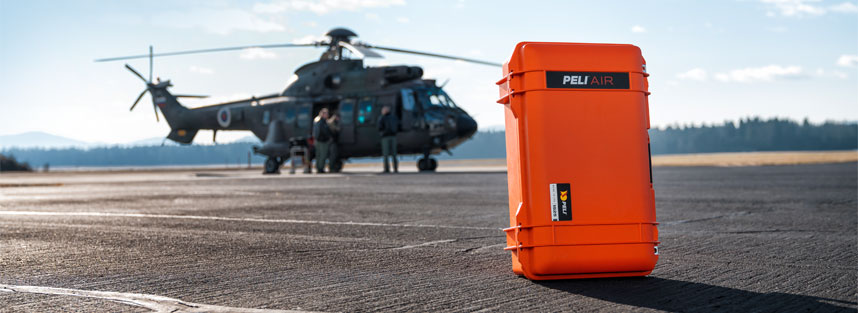 a Peli case with a helicopter in the background
