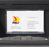 close up of a business card holder on a black peli case with the peli logo on the card