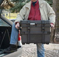 a man lifting two explorer 5140 tool cases into the boot of a car