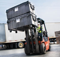 Peli 0550 transport cases being moved by an orange forklift