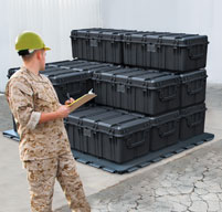 A member of the military checking peli 0550 transport cases on a pallet
