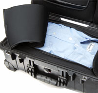 a close up of a Peli 1510LOC Laptop Overnight Cases storage compartment with a blue shirt inside