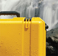 a close up of a black peli Storm case near a waterfall to show the case is watertight